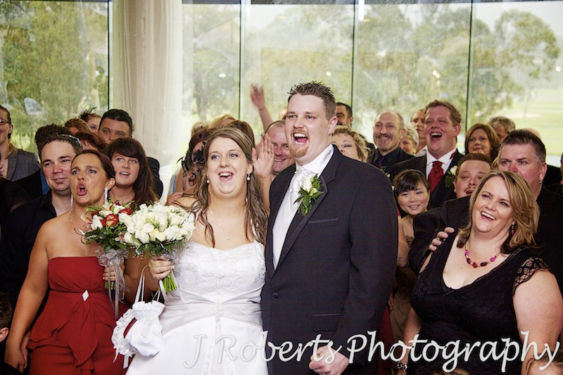 Bride and groom cheering with guests after ceremony - wedding photography sydney